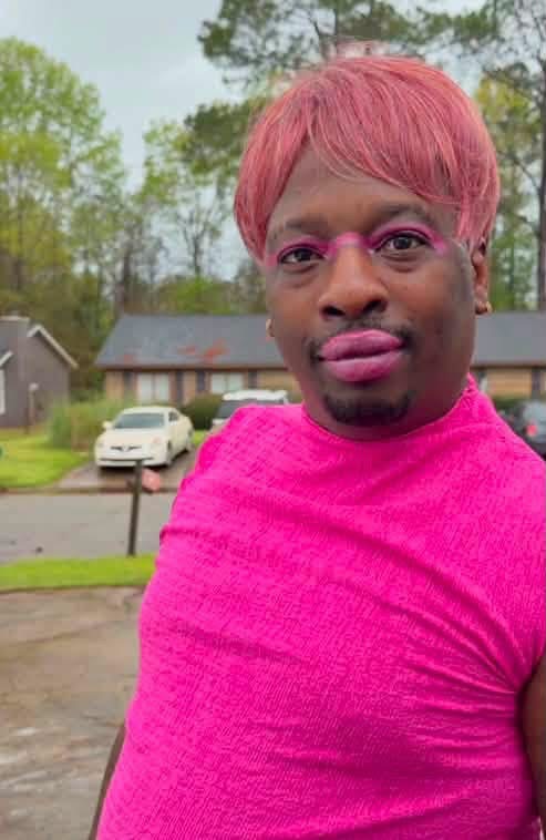 Laquanda badass wearing a bright pink outfit and pink hair